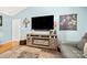 Living room with a console fireplace, hardwood floors, and a leather sofa at 5764 Grassy Creek Rd, Denver, NC 28037