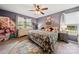 Cozy main bedroom featuring a floral bedding, a ceiling fan and natural light at 5764 Grassy Creek Rd, Denver, NC 28037