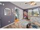 Bedroom with hardwood floors, ceiling fan, and a door to the bathroom at 5764 Grassy Creek Rd, Denver, NC 28037
