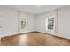 Bright bedroom with wood-look flooring, large windows, and neutral walls at 60 Valley Nw St, Concord, NC 28025