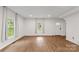 Spacious living room with wood-look flooring, large windows, and a front door at 60 Valley Nw St, Concord, NC 28025