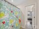 Bathroom featuring a shower-tub combo with a cheerful, patterned shower curtain at 603 Southstone Dr, Matthews, NC 28104