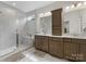 Modern bathroom with double vanity, sleek cabinets, and a luxurious glass shower at 603 Southstone Dr, Matthews, NC 28104