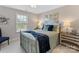 Inviting bedroom with a metal bed frame, soft bedding, and natural light streaming through the window at 603 Southstone Dr, Matthews, NC 28104