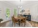 Cozy breakfast nook offers a round table, casual seating, and natural light from a glass patio door at 603 Southstone Dr, Matthews, NC 28104