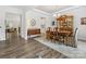 Open-concept dining room with hardwood floors, hutch, and view of living space at 603 Southstone Dr, Matthews, NC 28104