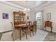 Elegant dining room boasts a classic china cabinet, tray ceiling, and decorative rug under the wood table at 603 Southstone Dr, Matthews, NC 28104