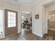 Bright foyer with hardwood floors leading to an office space with a work desk and decor at 603 Southstone Dr, Matthews, NC 28104