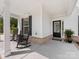 Inviting front porch with black rocking chairs, decorative plants, and a welcoming front door at 603 Southstone Dr, Matthews, NC 28104