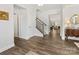 Hallway with hardwood flooring leading to the living areas, offering an open and inviting atmosphere at 603 Southstone Dr, Matthews, NC 28104