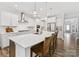 Spacious kitchen island with white countertops, bar seating, pendant lights, and stainless steel appliances at 603 Southstone Dr, Matthews, NC 28104