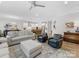 Open-concept living room flows into a modern kitchen, boasting hardwood floors and abundant natural light at 603 Southstone Dr, Matthews, NC 28104