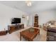 Cozy living room featuring neutral carpet and furniture, TV, and decorative shelving, perfect for relaxing and entertaining at 603 Southstone Dr, Matthews, NC 28104