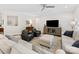 Spacious living room featuring neutral tones, stylish seating, and ceiling fan at 603 Southstone Dr, Matthews, NC 28104