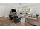 Spacious living room featuring hardwood floors, neutral furnishings, and large windows for plenty of natural light at 603 Southstone Dr, Matthews, NC 28104