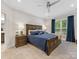 Comfortable bedroom with a rustic bed frame, ceiling fan, and natural light at 603 Southstone Dr, Matthews, NC 28104