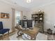 Well-lit office with large desk, computer setup, and decorative bookshelf at 603 Southstone Dr, Matthews, NC 28104