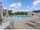 Community pool surrounded by lounge chairs and umbrellas, offering a relaxing and refreshing outdoor amenity at 603 Southstone Dr, Matthews, NC 28104