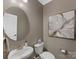 Cozy powder room featuring a stylish round mirror and an elegant floral painting at 603 Southstone Dr, Matthews, NC 28104