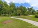 Scenic walking path winding through a grassy area with mature trees, perfect for enjoying nature and staying active at 603 Southstone Dr, Matthews, NC 28104