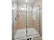 Shower features tiled walls, glass doors, and built-in shelving for convenience at 6037 Chelsea Oaks Rdg # 77, Tega Cay, SC 29708