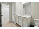 Bright bathroom with white cabinets, a large mirror, and neutral tile flooring at 6037 Chelsea Oaks Rdg # 77, Tega Cay, SC 29708