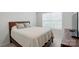 Bedroom featuring a queen-sized bed with gray bedding and large window at 6037 Chelsea Oaks Rdg # 77, Tega Cay, SC 29708