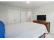 Carpeted bedroom with double closets and a television atop a wood dresser at 6037 Chelsea Oaks Rdg # 77, Tega Cay, SC 29708