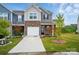 Charming townhome with well-manicured lawn, attached garage, and inviting curb appeal at 6037 Chelsea Oaks Rdg # 77, Tega Cay, SC 29708