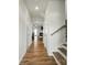 Inviting hallway with wood floors, leading to dining area and featuring a staircase at 6037 Chelsea Oaks Rdg # 77, Tega Cay, SC 29708