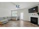 Bright living room features a ceiling fan, fireplace, modern finishes, and access to a door at 6037 Chelsea Oaks Rdg # 77, Tega Cay, SC 29708