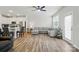 Open-concept living room with modern finishes, ceiling fan, wood flooring, and kitchen view at 6037 Chelsea Oaks Rdg # 77, Tega Cay, SC 29708