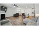 Spacious living room with fireplace, ceiling fan, and open layout to the kitchen and dining area at 6037 Chelsea Oaks Rdg # 77, Tega Cay, SC 29708