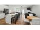 Open-concept living space featuring kitchen island with seating and a comfortable living room at 6037 Chelsea Oaks Rdg # 77, Tega Cay, SC 29708
