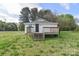 Backyard view of home with deck and stairs and expansive lawn at 6124 Old Mt Holly Rd, Charlotte, NC 28208