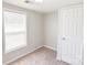 Simple bedroom design with a single window, neutral paint, and neutral carpet at 6124 Old Mt Holly Rd, Charlotte, NC 28208