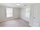 Cozy bedroom featuring neutral carpet, bright windows and a door leading to other rooms at 6124 Old Mt Holly Rd, Charlotte, NC 28208