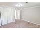 Serene bedroom features plush carpeting, a closet, and a door to the bathroom at 6124 Old Mt Holly Rd, Charlotte, NC 28208