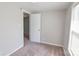 Cozy bedroom with a window and neutral walls with neutral carpet, offering comfort and tranquility at 6124 Old Mt Holly Rd, Charlotte, NC 28208