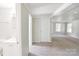 Hallway featuring neutral walls, carpet, and doors leading to other rooms in the house at 6124 Old Mt Holly Rd, Charlotte, NC 28208