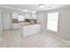 Bright eat-in kitchen with white cabinets, tile flooring, and white appliances at 6124 Old Mt Holly Rd, Charlotte, NC 28208