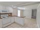 Well-lit kitchen boasts white cabinets, ample counter space, and tile flooring at 6124 Old Mt Holly Rd, Charlotte, NC 28208