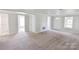 Open-concept living room showcasing neutral carpet and access to other rooms in the house at 6124 Old Mt Holly Rd, Charlotte, NC 28208