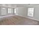 Bright living room with large windows and neutral carpet provides a welcoming atmosphere at 6124 Old Mt Holly Rd, Charlotte, NC 28208