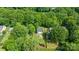 Aerial view of a home with a well-manicured lawn, patio and lush landscaping, surrounded by mature trees at 618 Heathermoor Ct, Charlotte, NC 28209