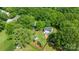Aerial view of the home's fenced backyard, shed, firepit, playset and beautiful trees surrounding the property at 618 Heathermoor Ct, Charlotte, NC 28209
