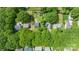 Aerial view of a neighborhood with lush green trees and homes below providing an overview of the community at 618 Heathermoor Ct, Charlotte, NC 28209