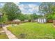 Expansive backyard with lush lawn, shed, play equipment, and patio area for outdoor enjoyment at 618 Heathermoor Ct, Charlotte, NC 28209