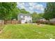 Large, fenced backyard with a patio, fire pit, and green space, creating a private retreat at 618 Heathermoor Ct, Charlotte, NC 28209