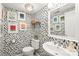 Unique powder room with bold wallpaper, modern vanity, and stylish fixtures at 618 Heathermoor Ct, Charlotte, NC 28209